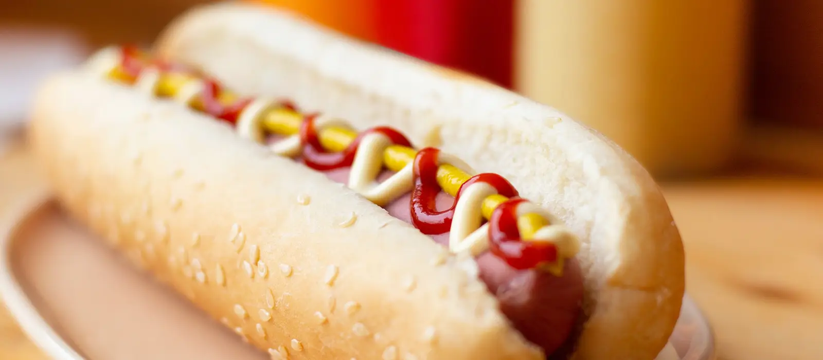 Hotdog with mustard and tomato sauce