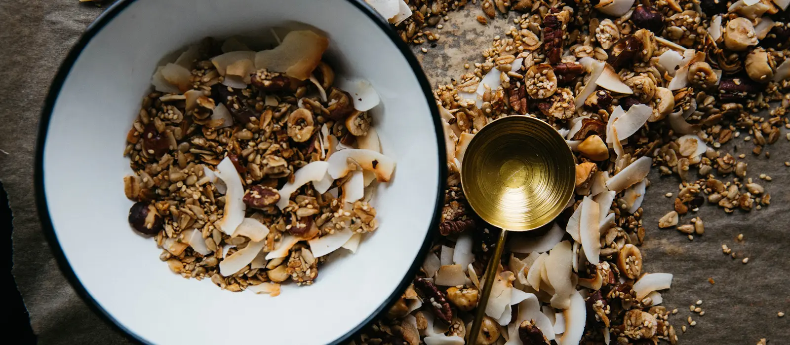 Bowl of homemade granola with measuring cup