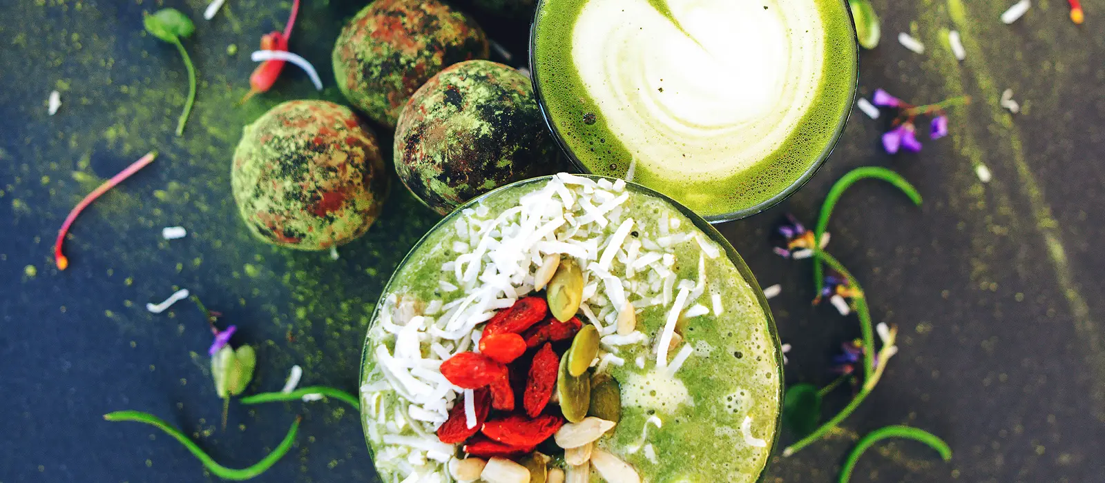 Selection of matcha energy balls, smoothie and latte